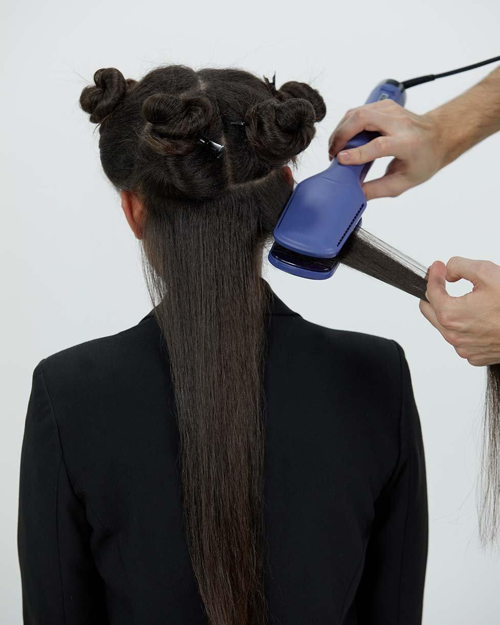 Stylist setzt ghd duet style an einer Strähne an