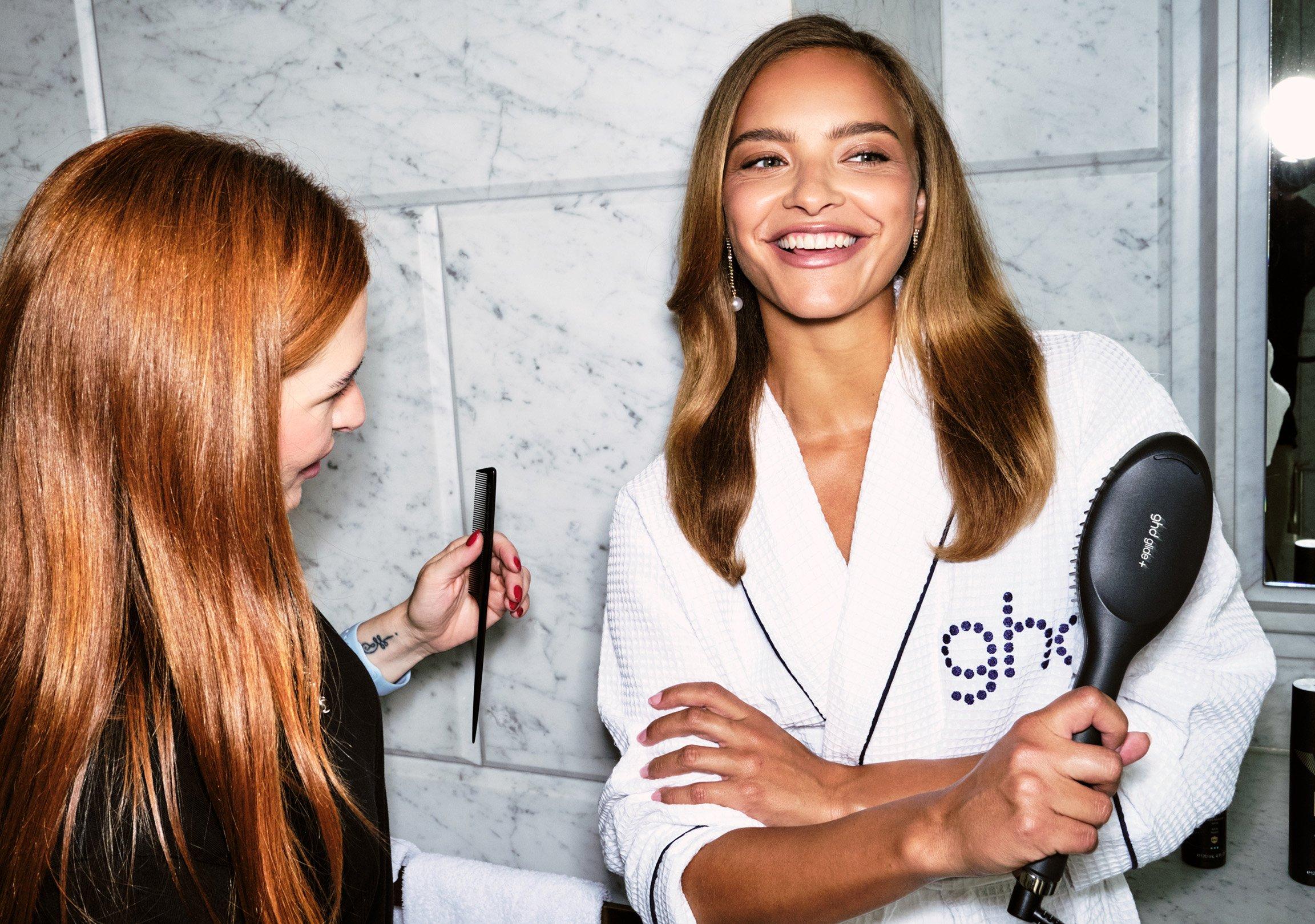 model holding ghd Glide+ with ultra smooth hair