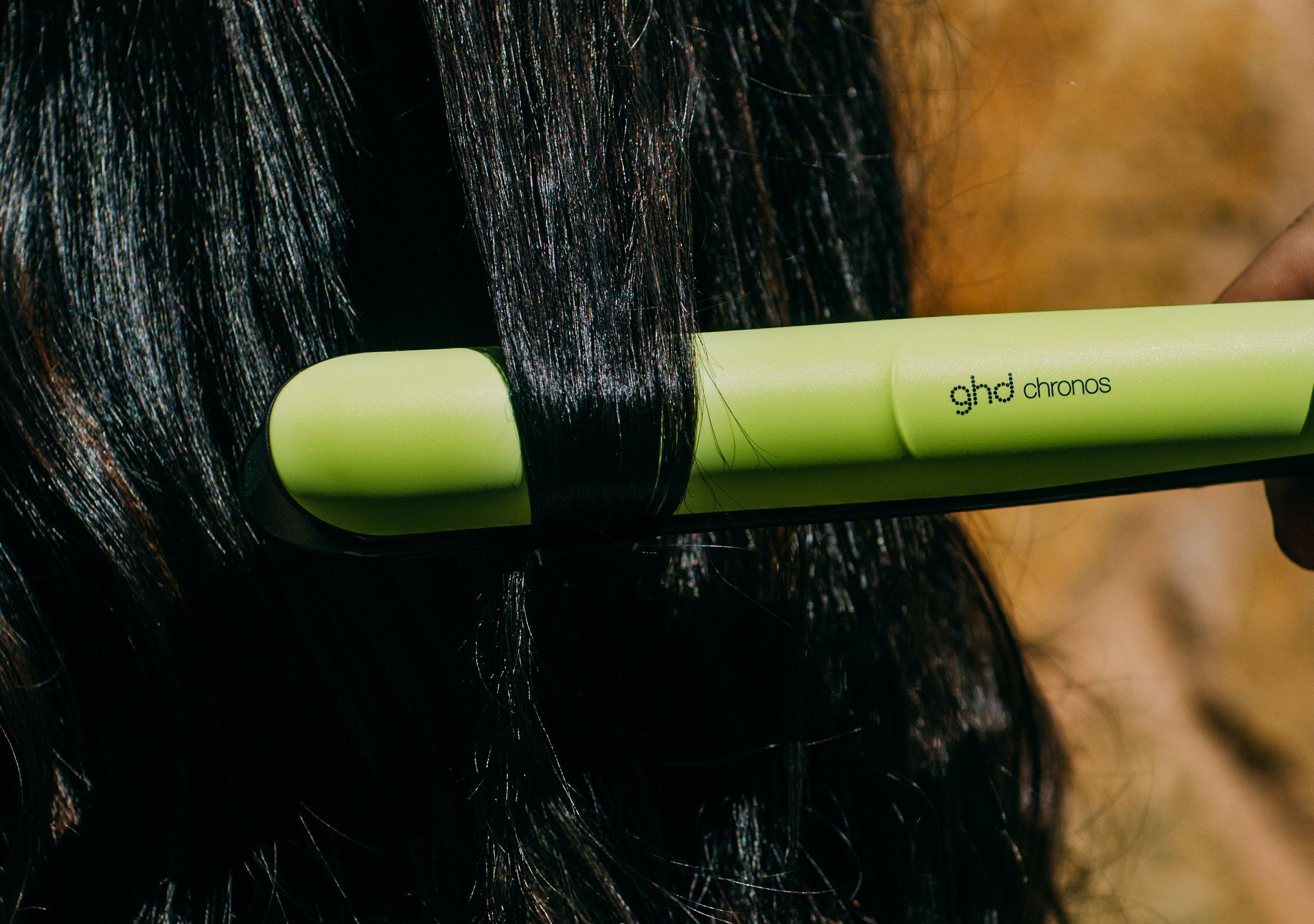 Hair straightener on model&apos;s hair