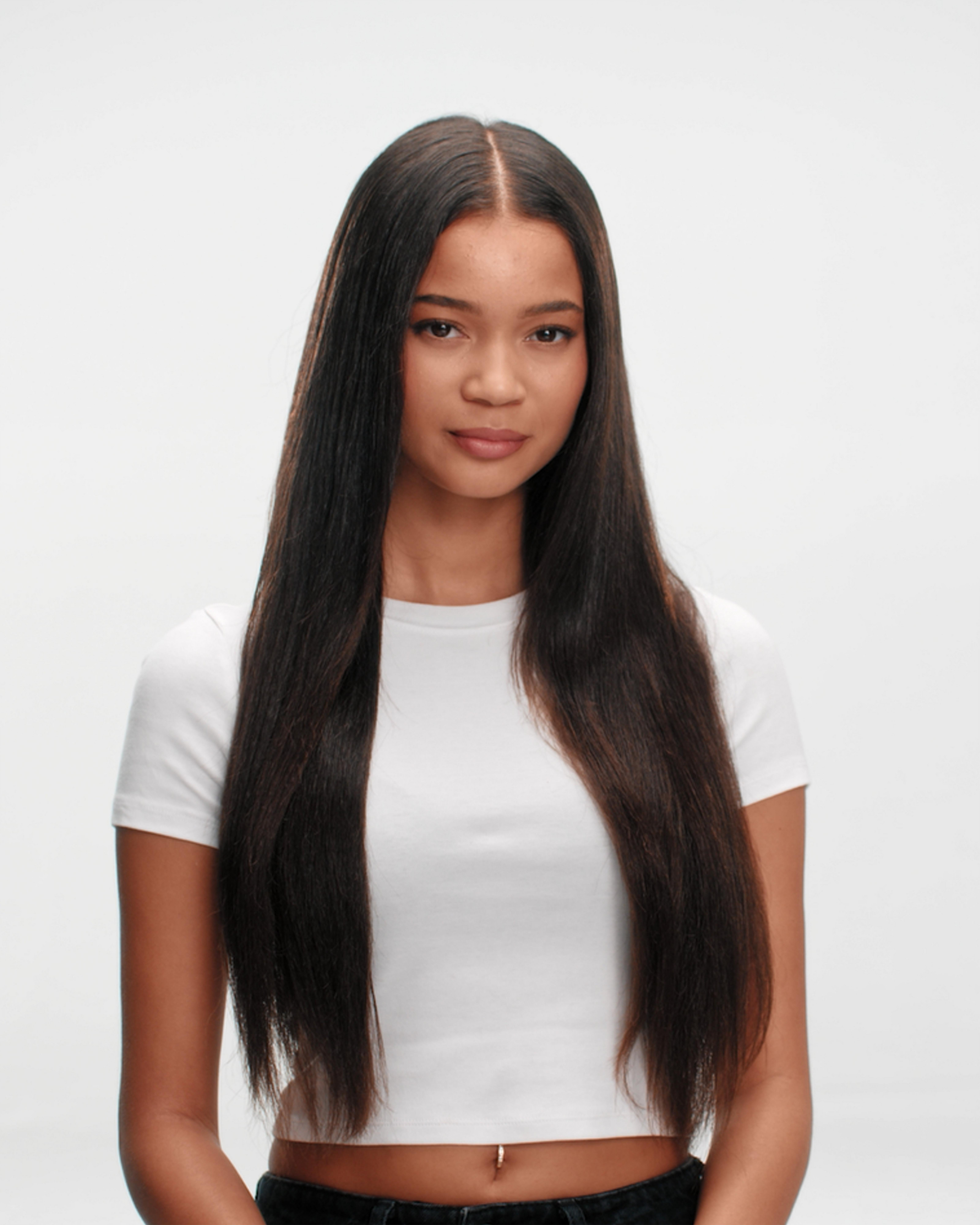 model with long thick and curly hair with hair styled showing ultra smooth results achieved by ghd glide+ max