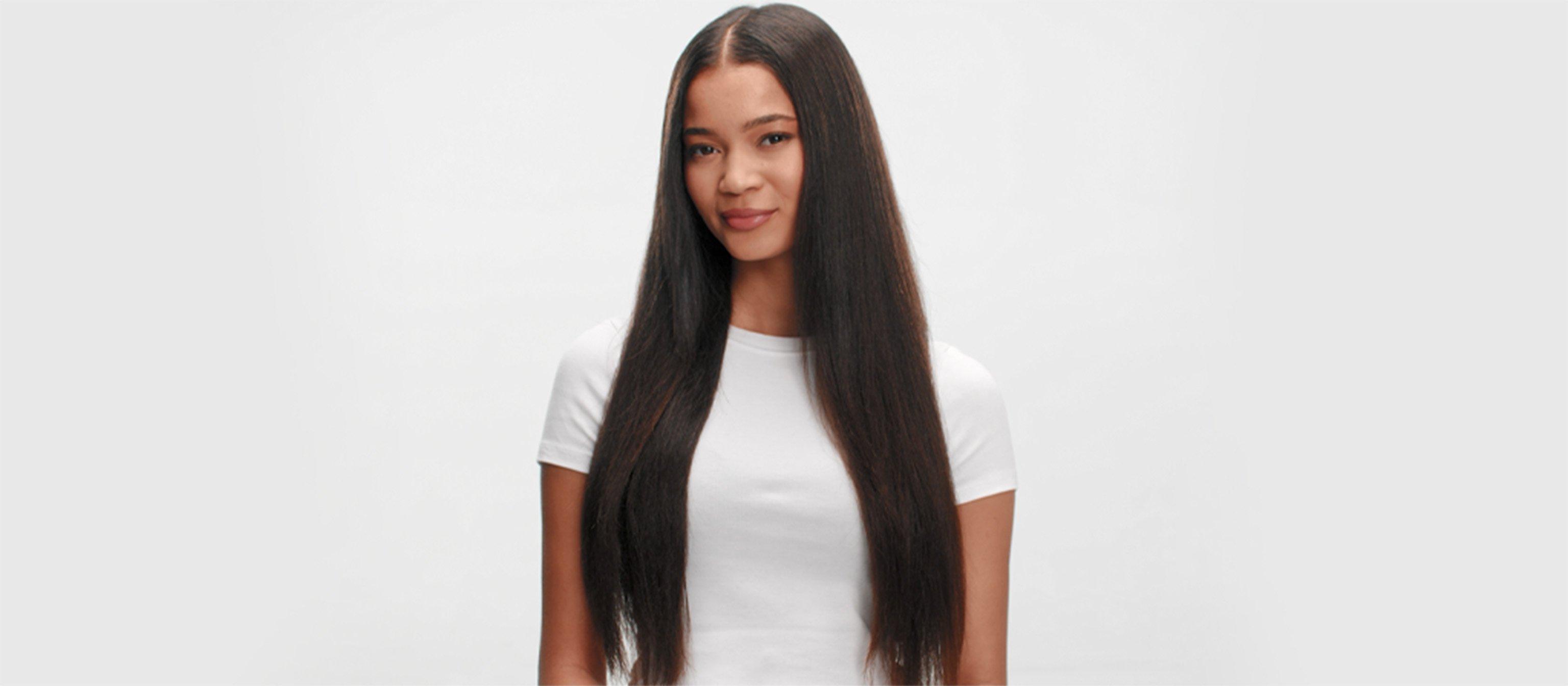 model with long thick curly hair styled using the ghd glide+ max