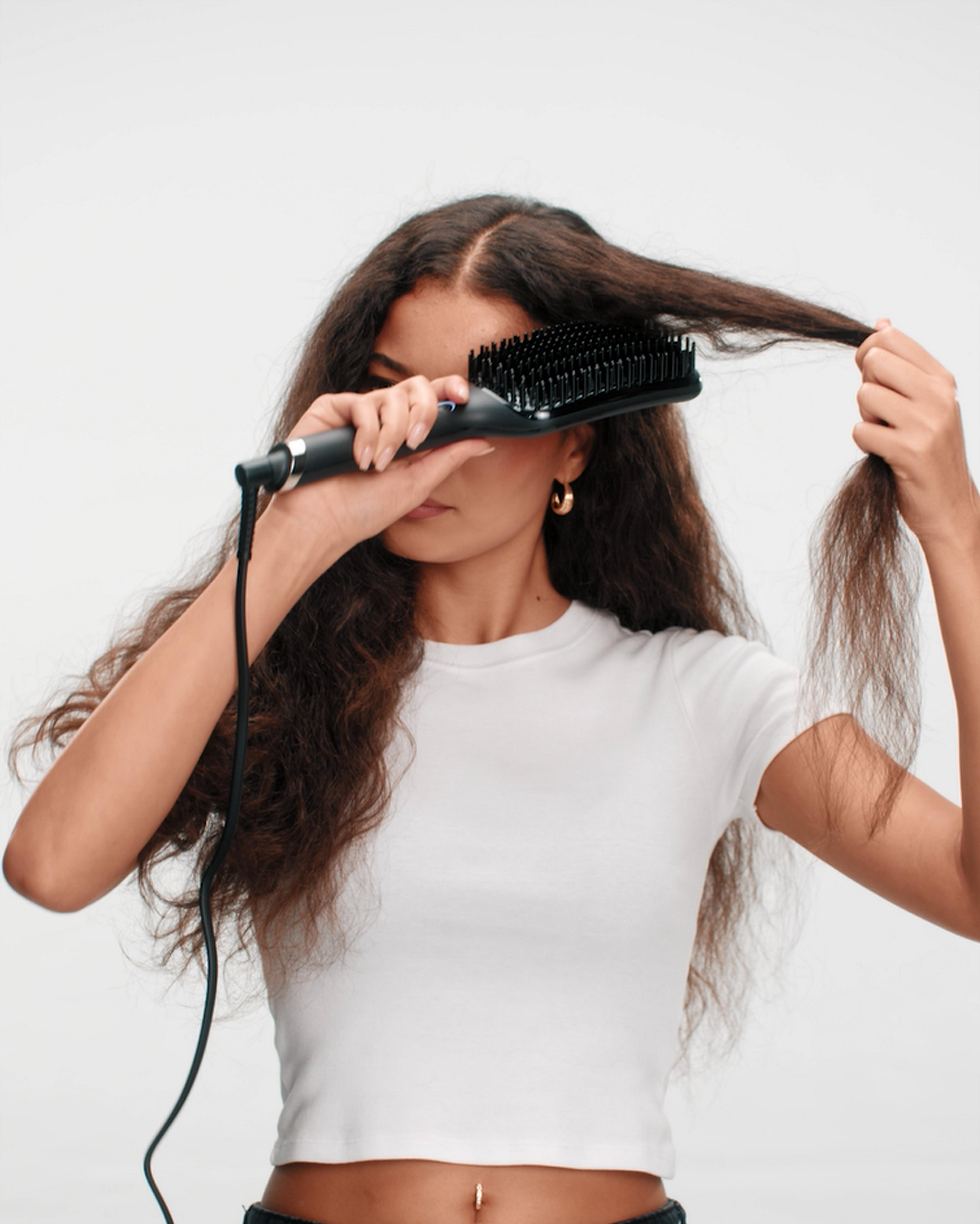 model taking a section of hair ready to style