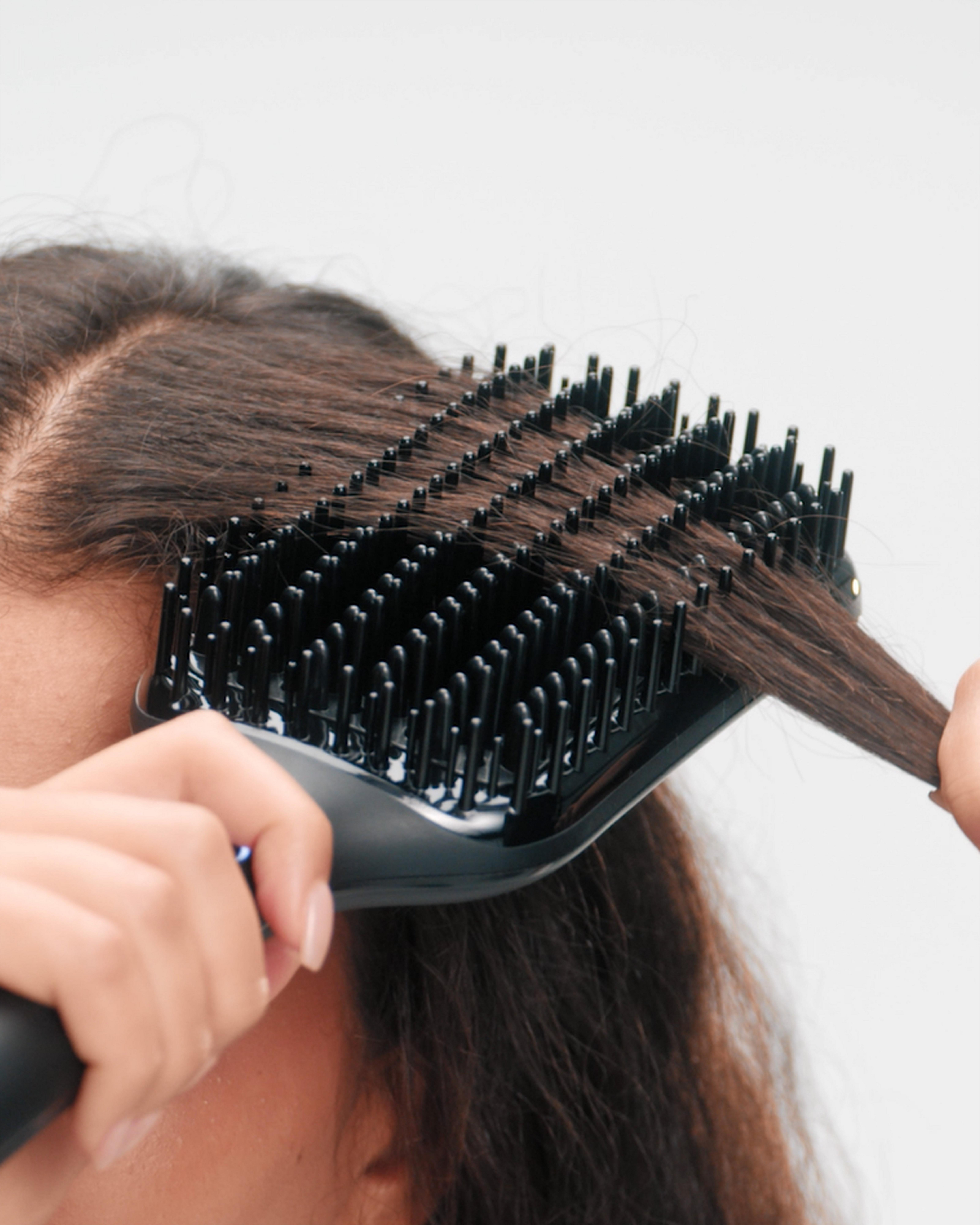 model taking ghd glide+ max to the root