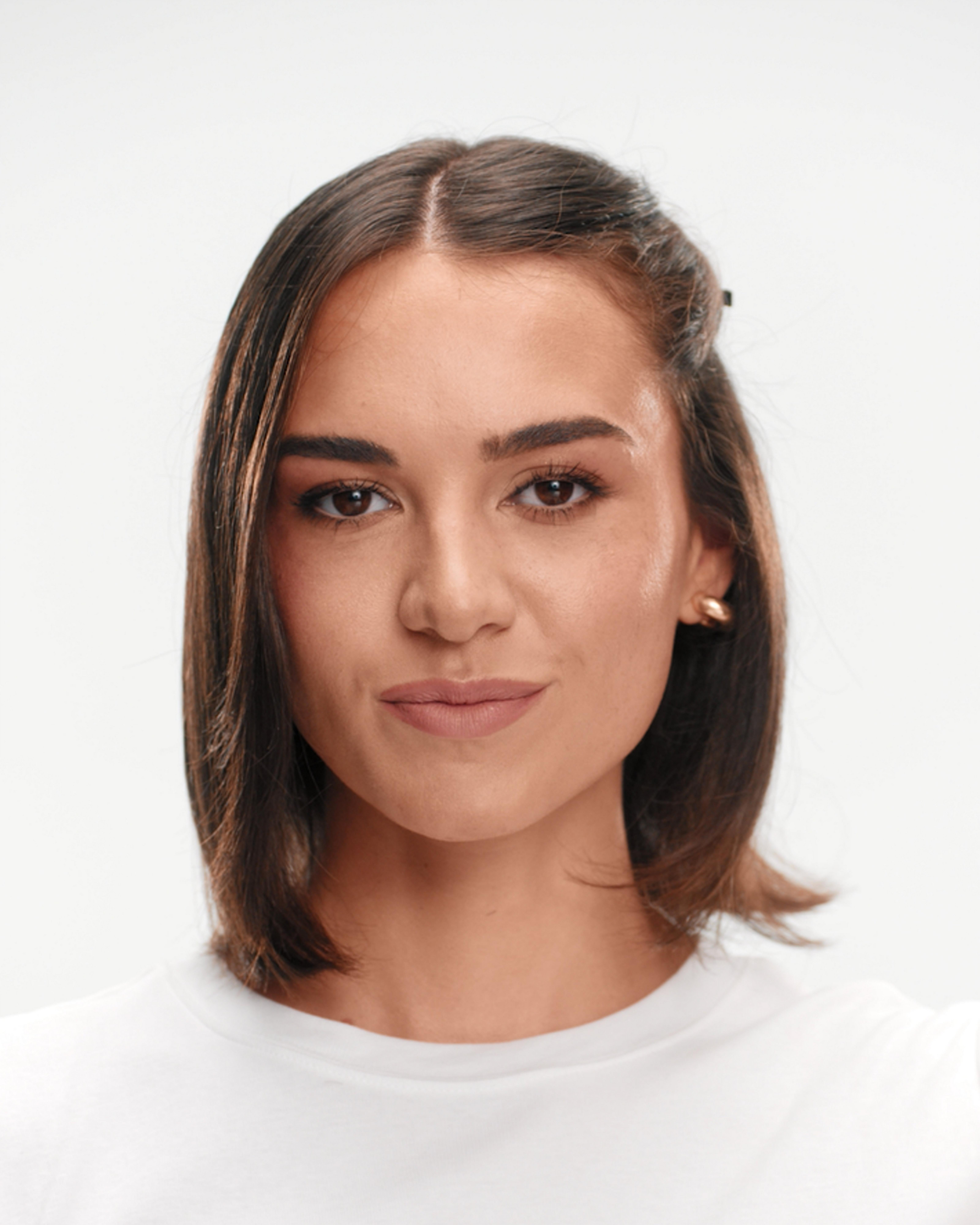 model sectioning her hair with a clip